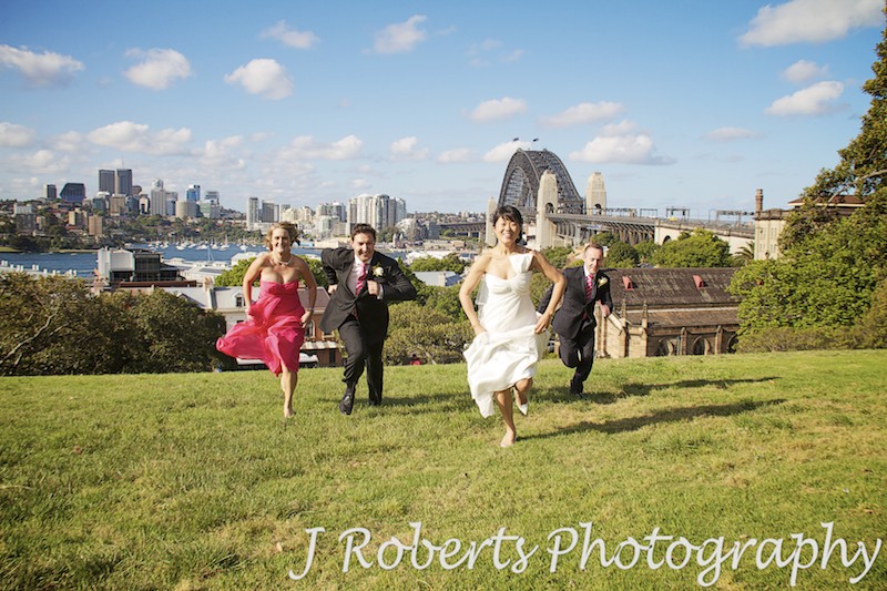 Bridal party running up observatory hill - wedding photography sydney